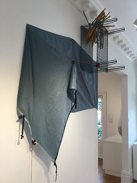 Sanctuary, 2019, tent fragment, shelf, coat hangers, tent poles